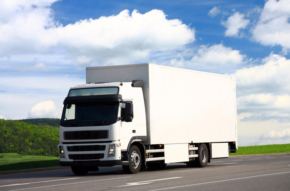 A white diesel-powered truck on the road.