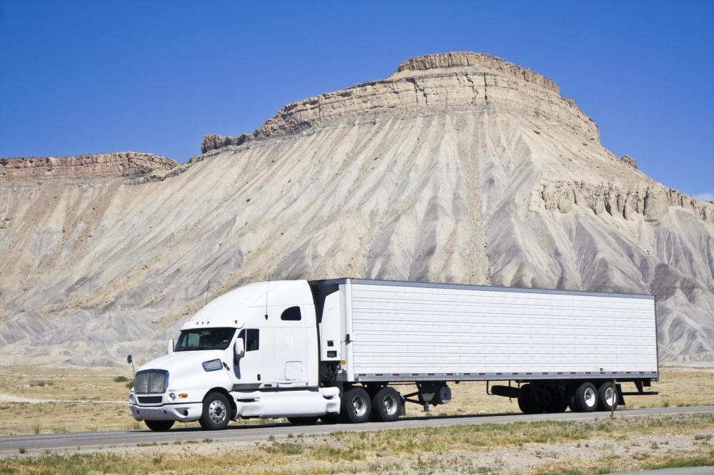  A white diesel truck on a road powered by an ECM module.