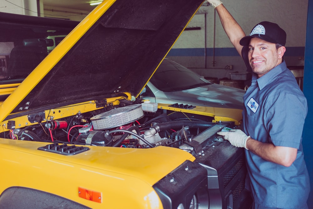 Mechanic checking a yellow car