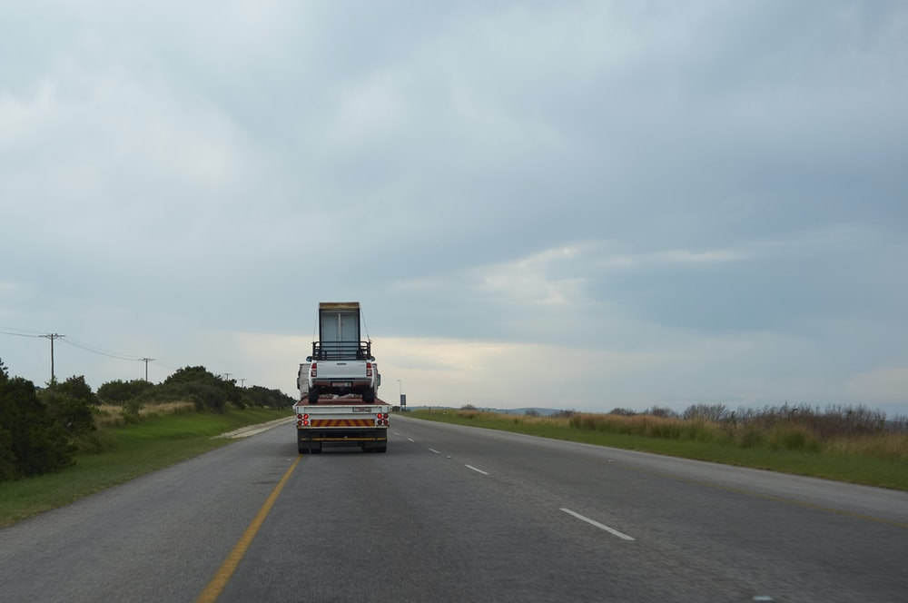 A highway truck transporting a car 