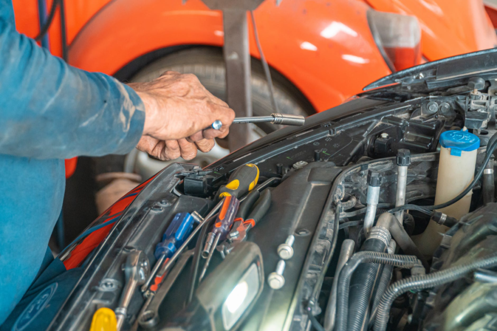 A mechanic repairing a car 