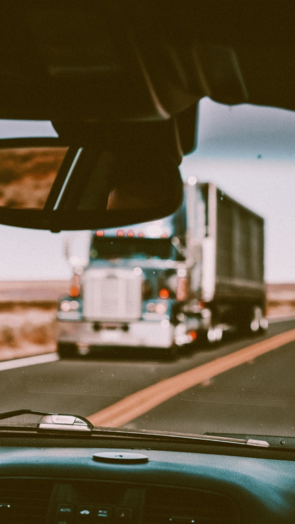 A truck being viewed through another vehicle’s windshield