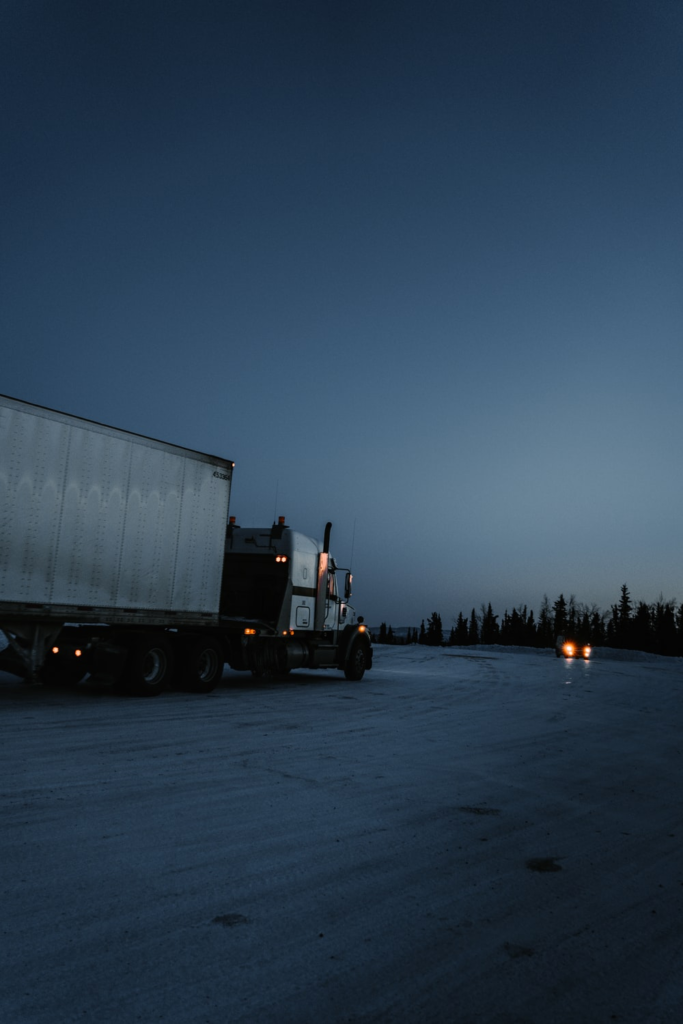 A truck with a trailer driving along a road