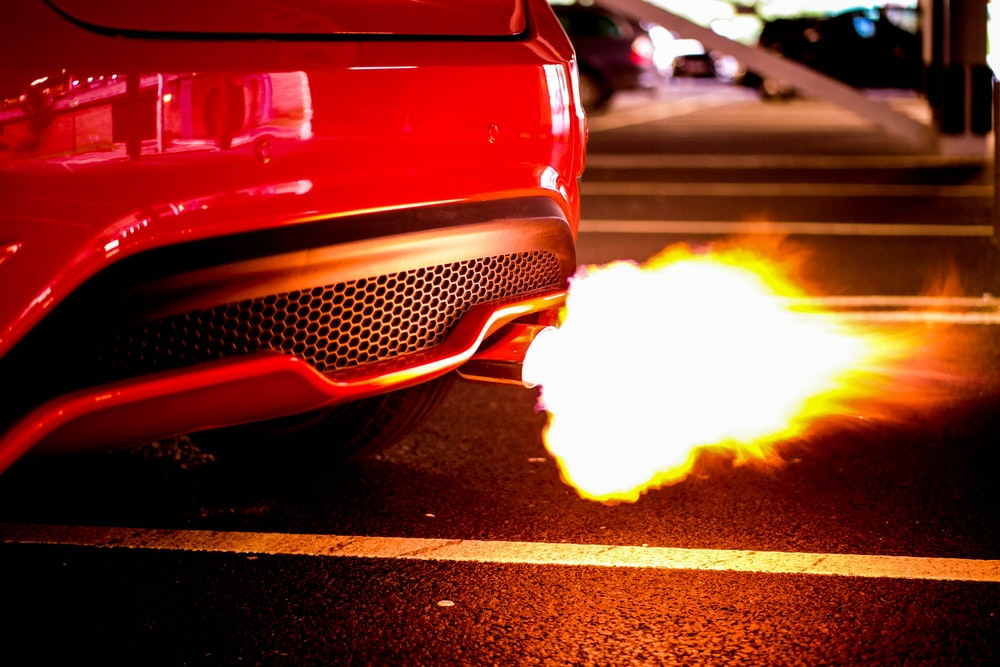 a red car backfiring