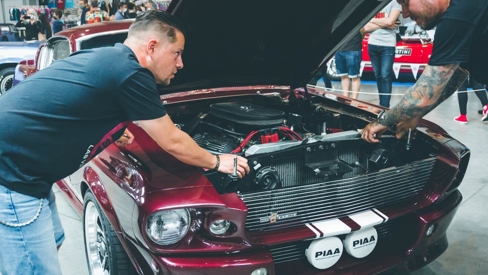 auto mechanics fixing a car