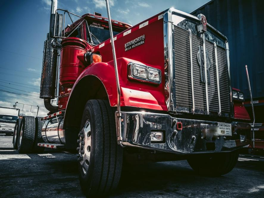 A worm’s-eye view of a parked red truck.