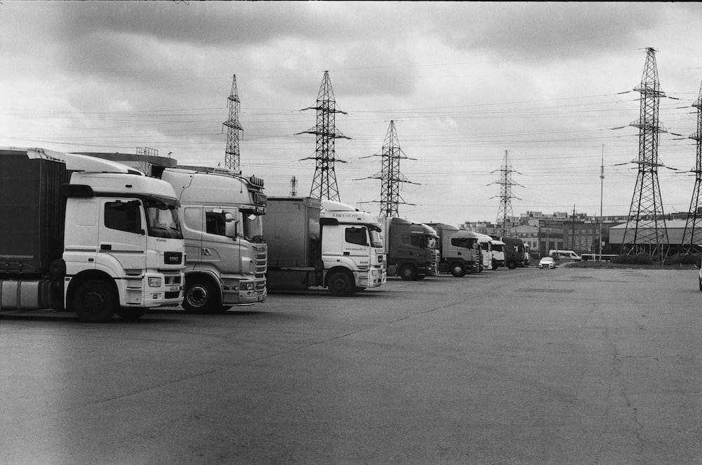 Grayscale of a truck stop during daytime.