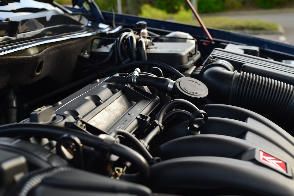 Close-up of the engine bay of a car during daytime.