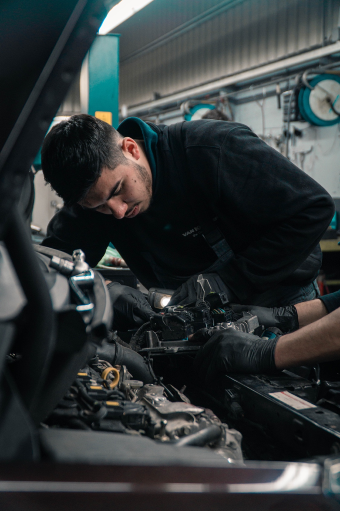 A professional mechanic working on an engine