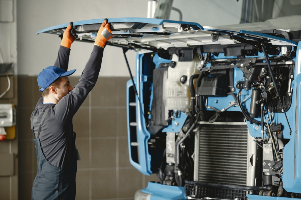  A professional inspecting a truck’s engine